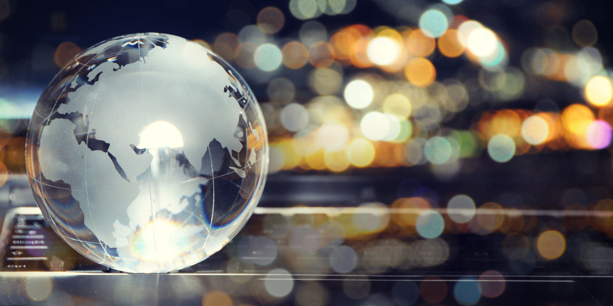 Glass,Crystal,Globe,On,Laptop,Keyboard